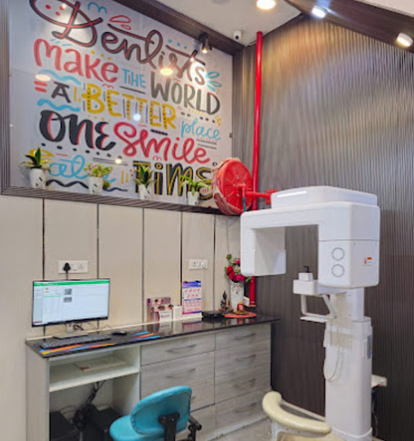 In-house OPG and CBCT unit beside the reception desk at Perfect 32 Dental Clinic