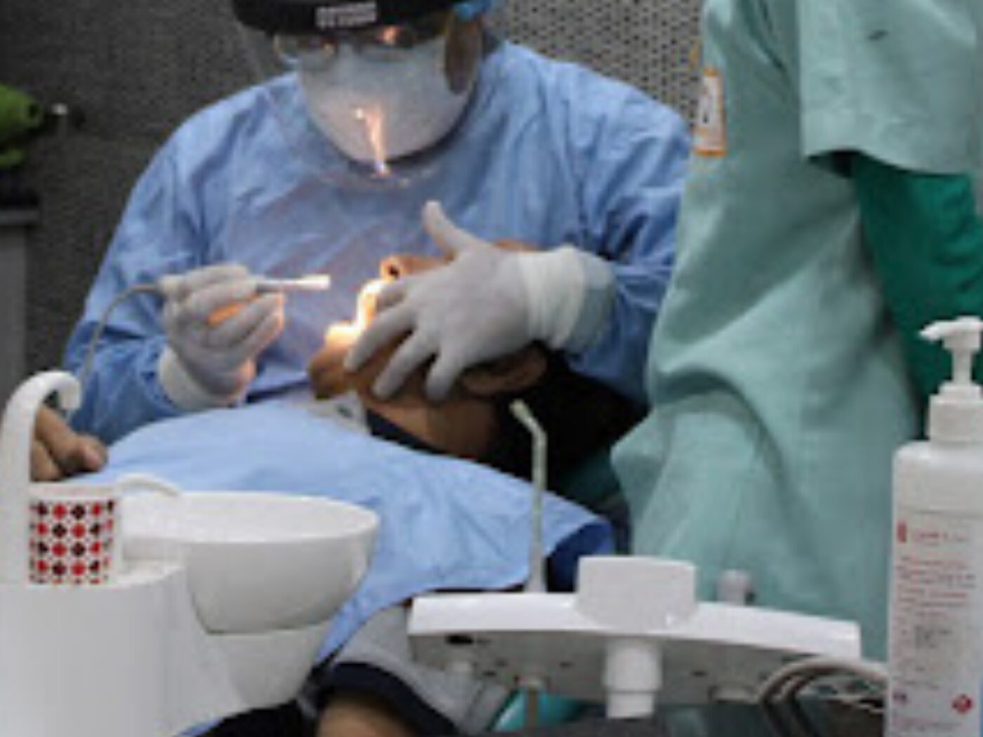 Dr. Rohit Batra carrying out a procedure with magnification loupes